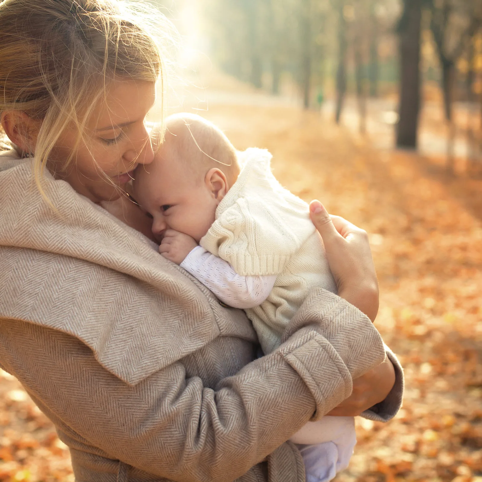 Mutter hält ihr Baby – freie Taufe und Willkommensfeier